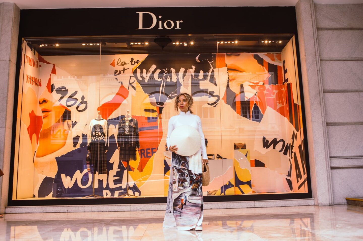 woman standing in front of dior store front