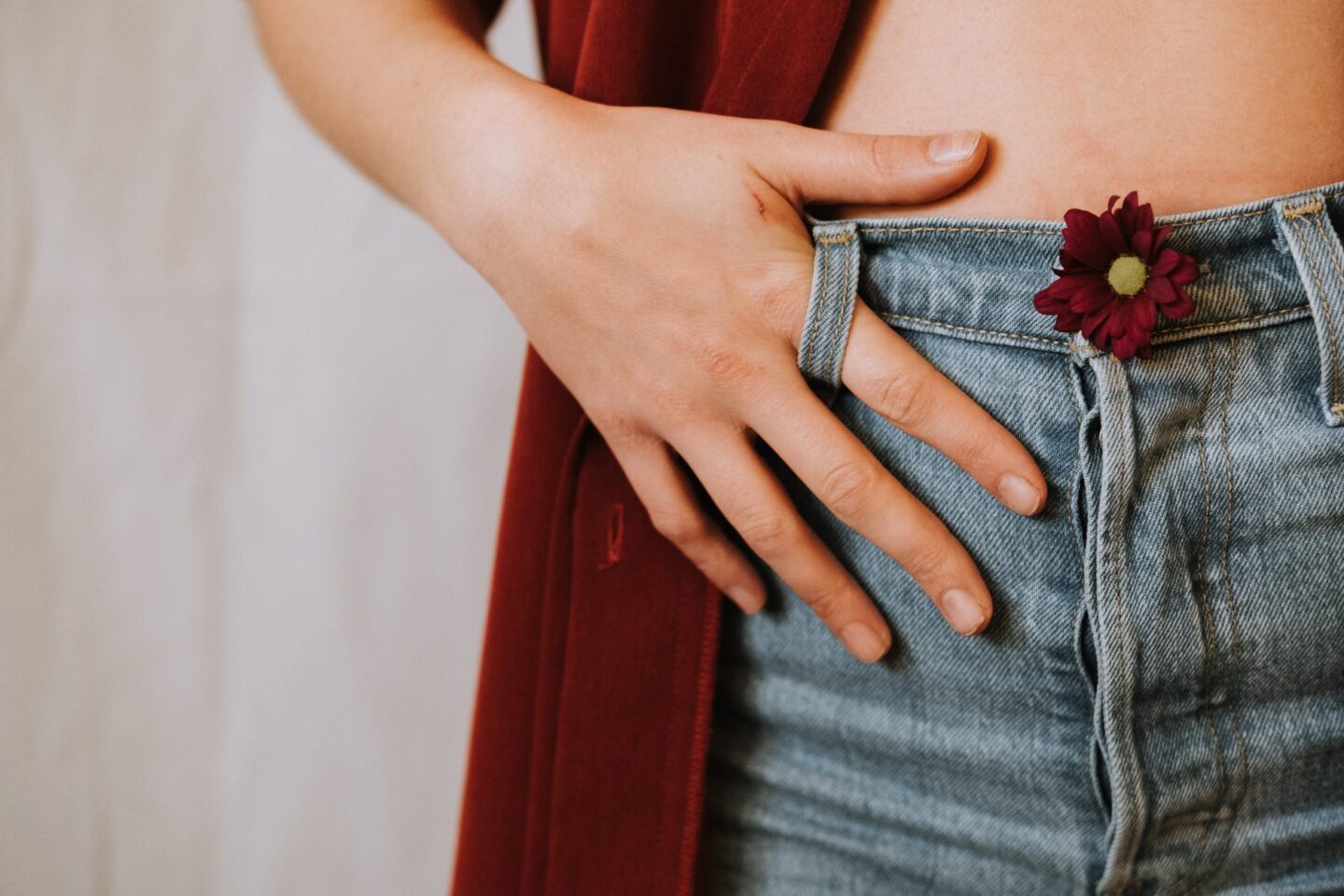 woman in jeans with blooming flower