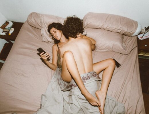 couple having sex and using smartphone