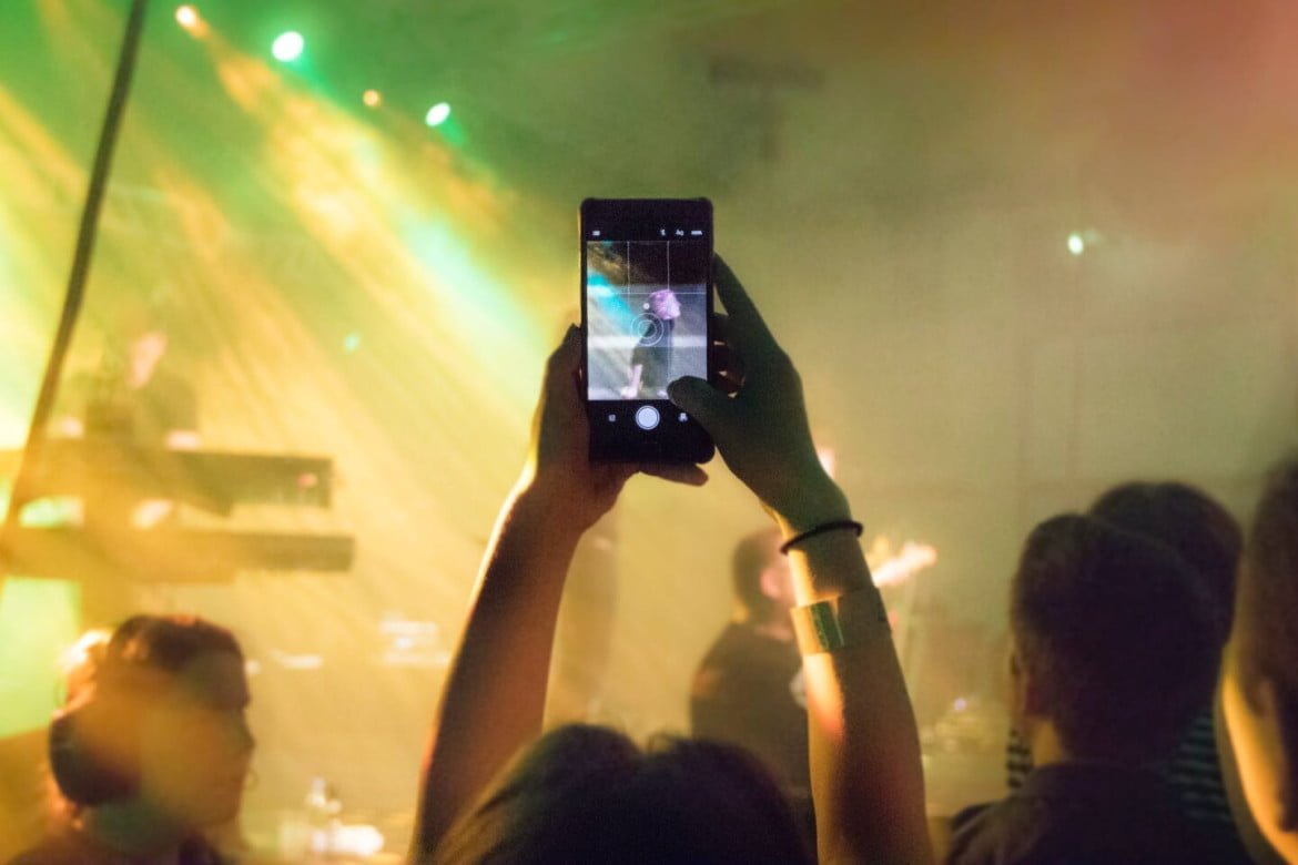 person holding smartphone inside bar