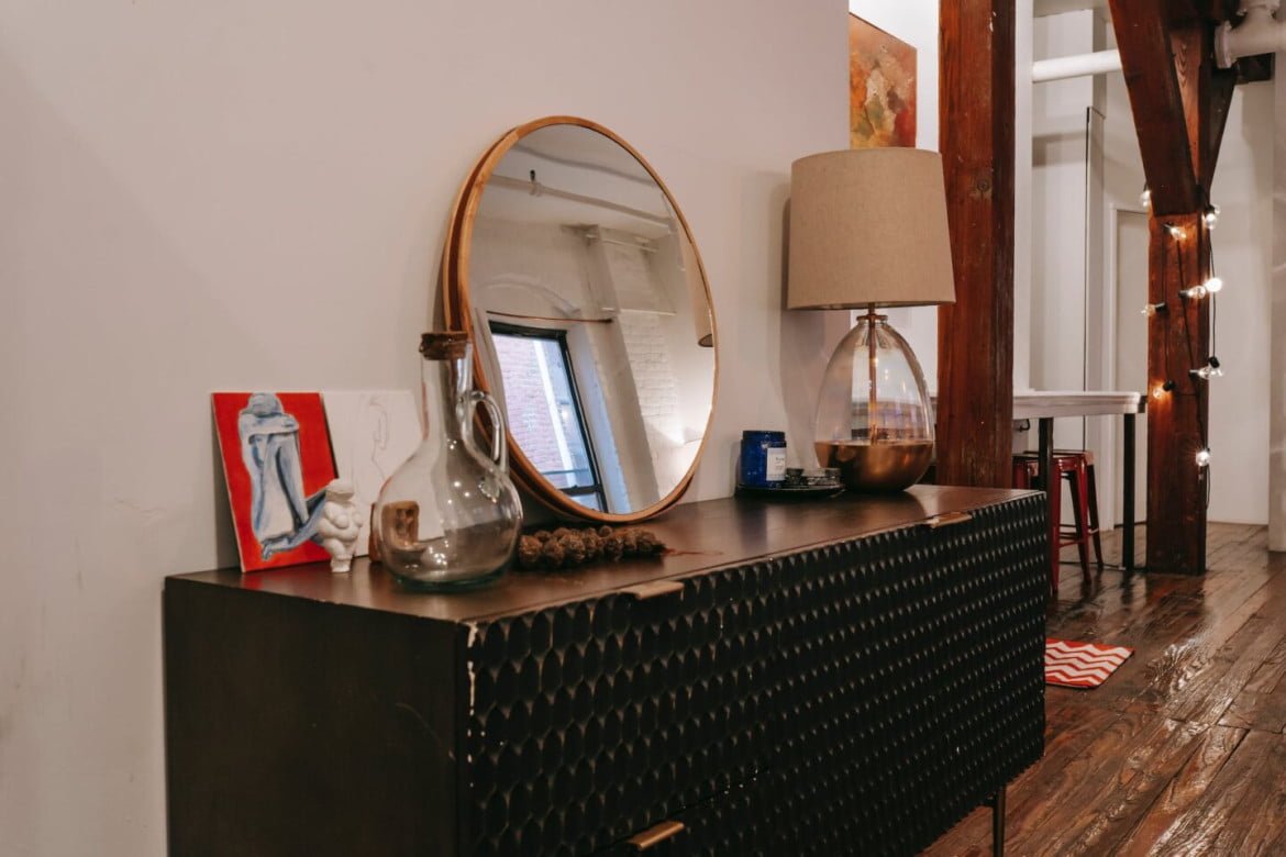 black dresser with mirror in room