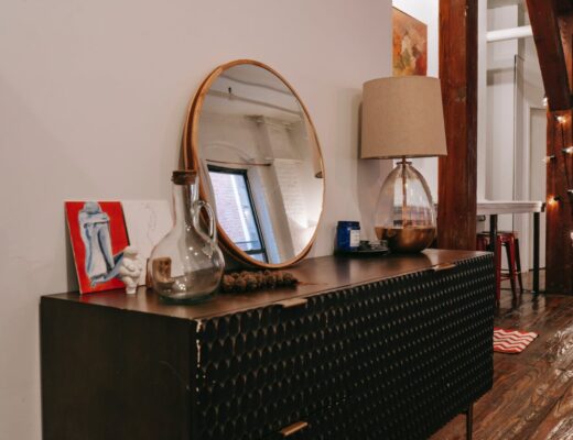 black dresser with mirror in room