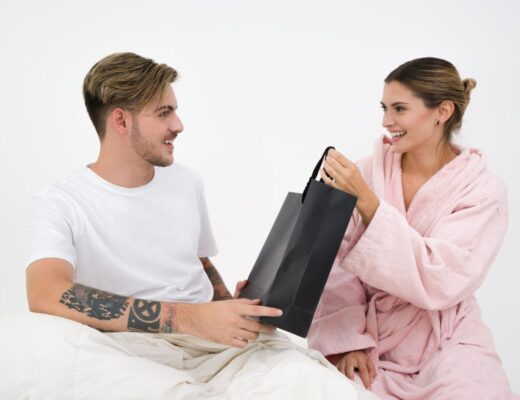 man and woman holding black tote bag